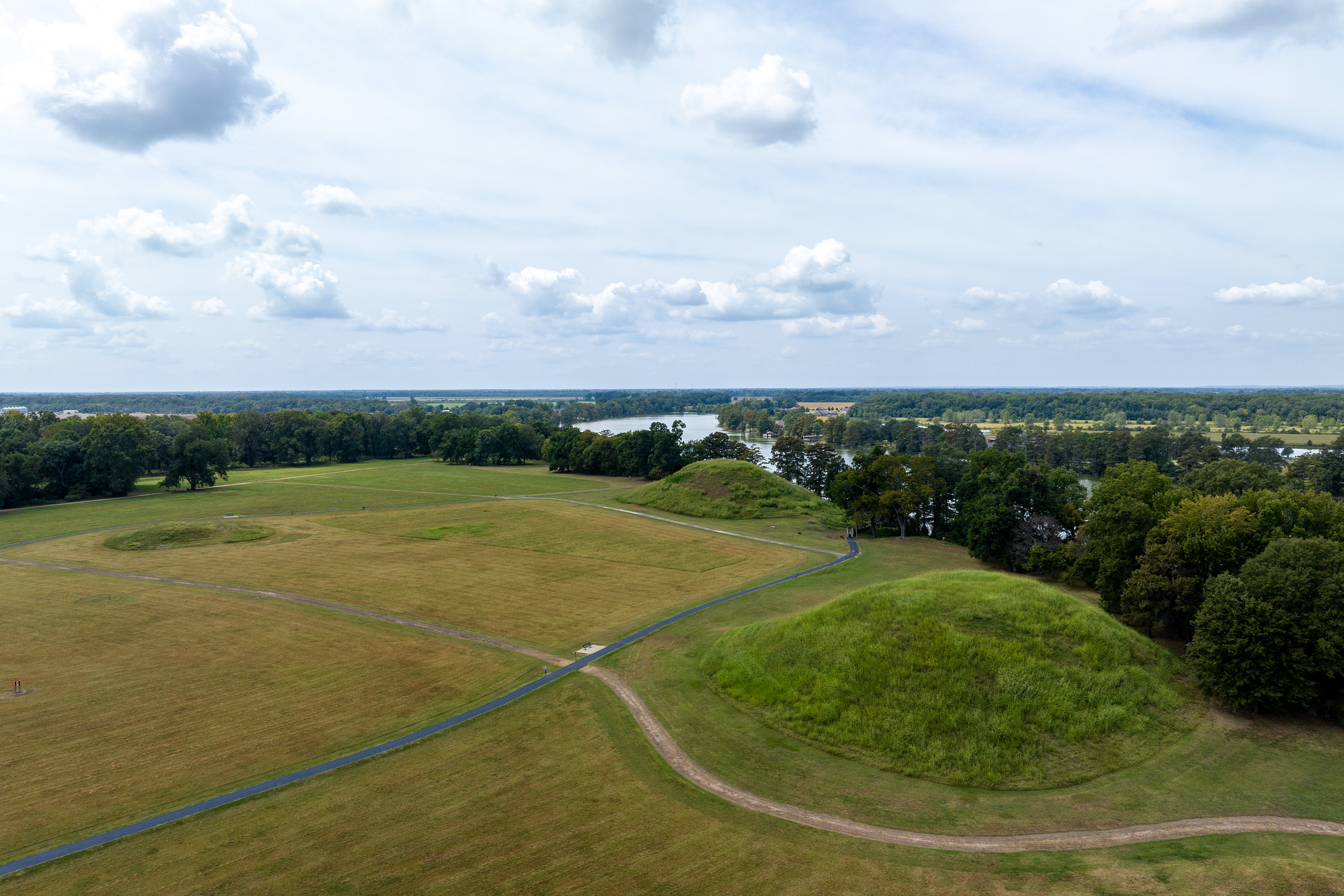 Aerial view of Plum Bayou State Park facing a large grassy field outlined by trees